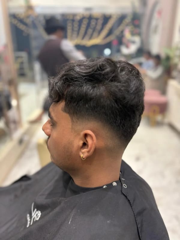 a man with a black haircut in a barber
