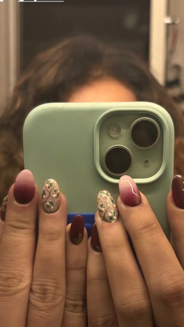 a woman holding a green phone case