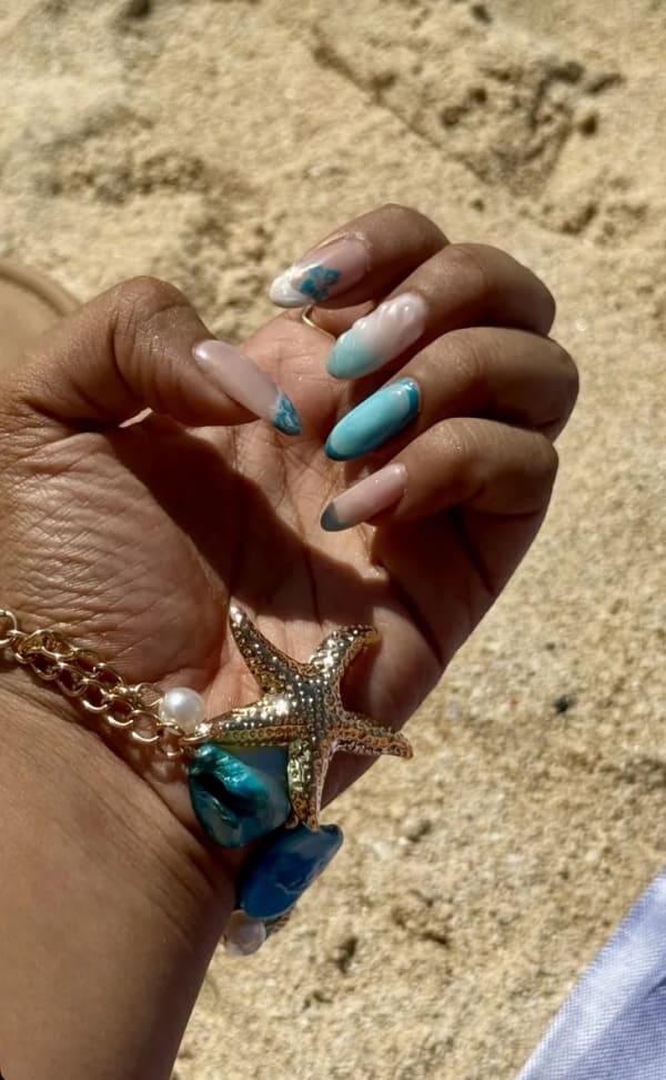 a woman holding a starfish on her wrist