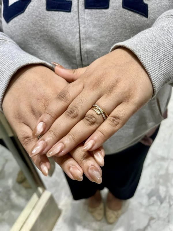a woman holding her hands with a ring on her finger