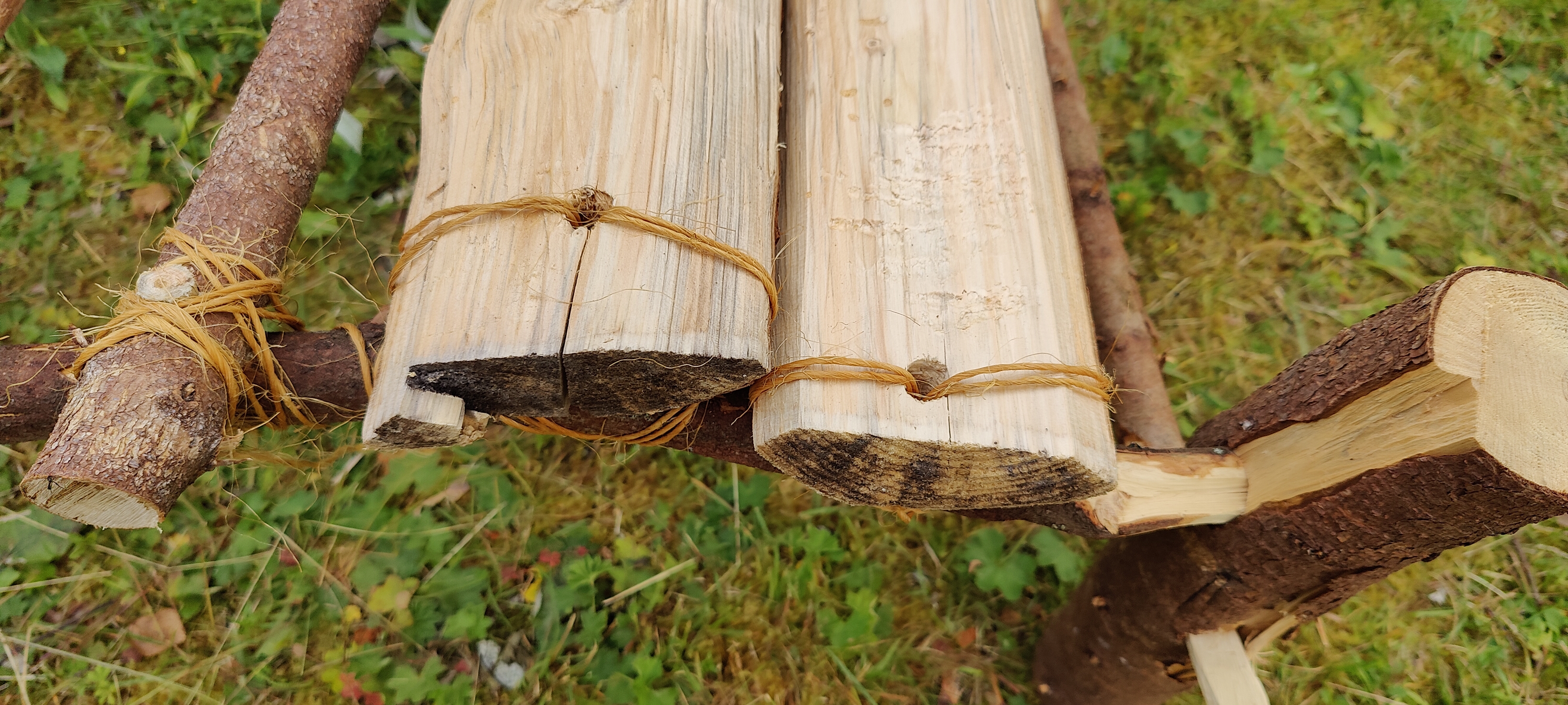 Boards are fastened with twine as the branches were to thin to drill through
