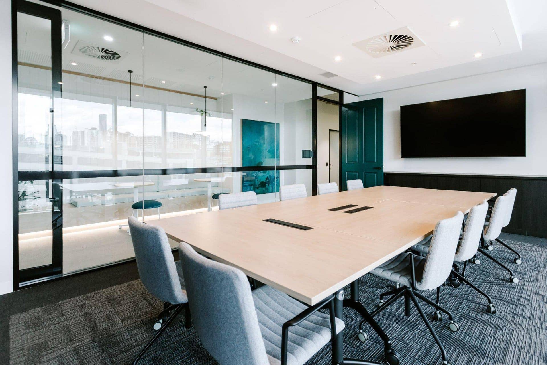 modern meeting room design with large table and a tv screen