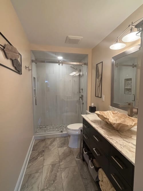Denville NJ Bathroom 1 - Completed - Wide view of Glass shower, tile walls and floors, quartzite countertop and sink Denville NJ Bathroom 1 - Completed - Wide view of Glass shower, tile walls and floors, quartzite countertop and sink