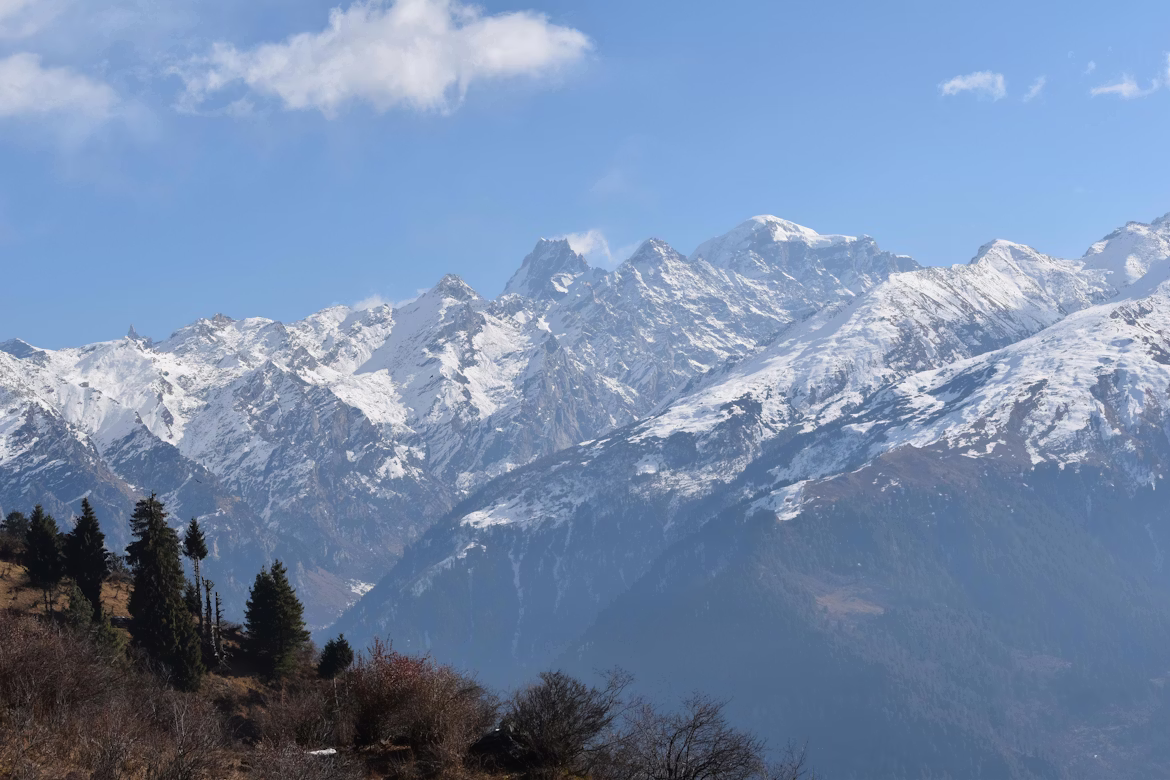 Stunning view of snow-capped Himalayan mountain peaks near Manali under a clear blue sky.