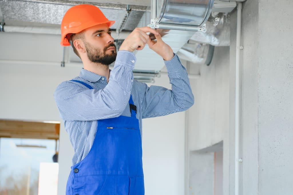 hvac worker install ducted pipe system for ventilation and air conditioning. copy space