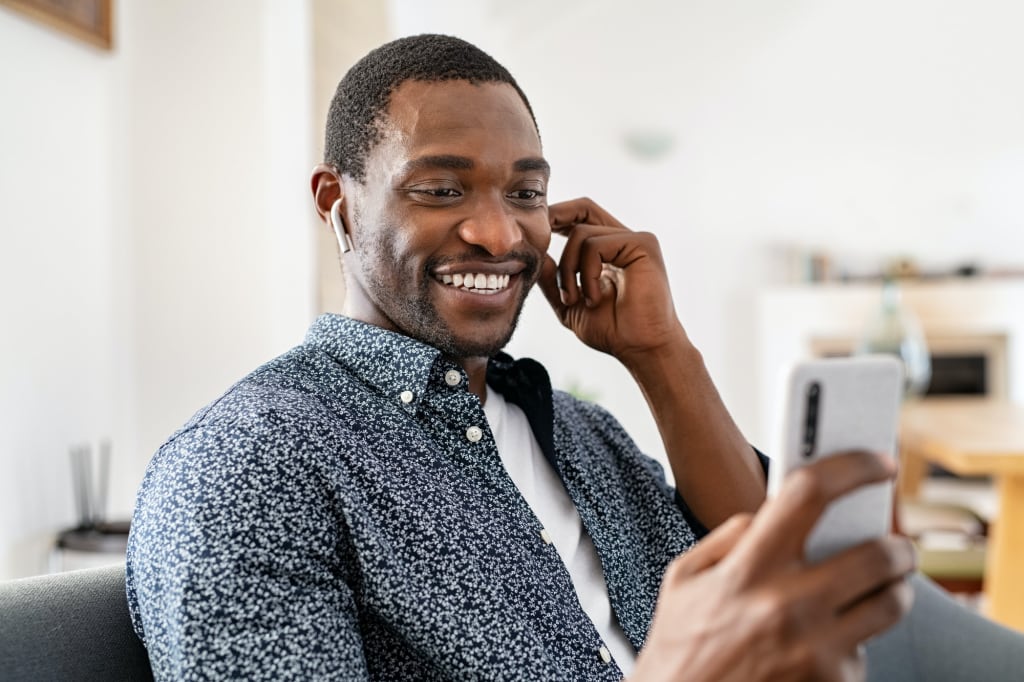 Happy mature man doing video call at home