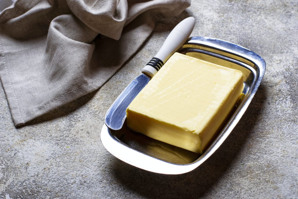 Fresh butter and knife in butter-dish