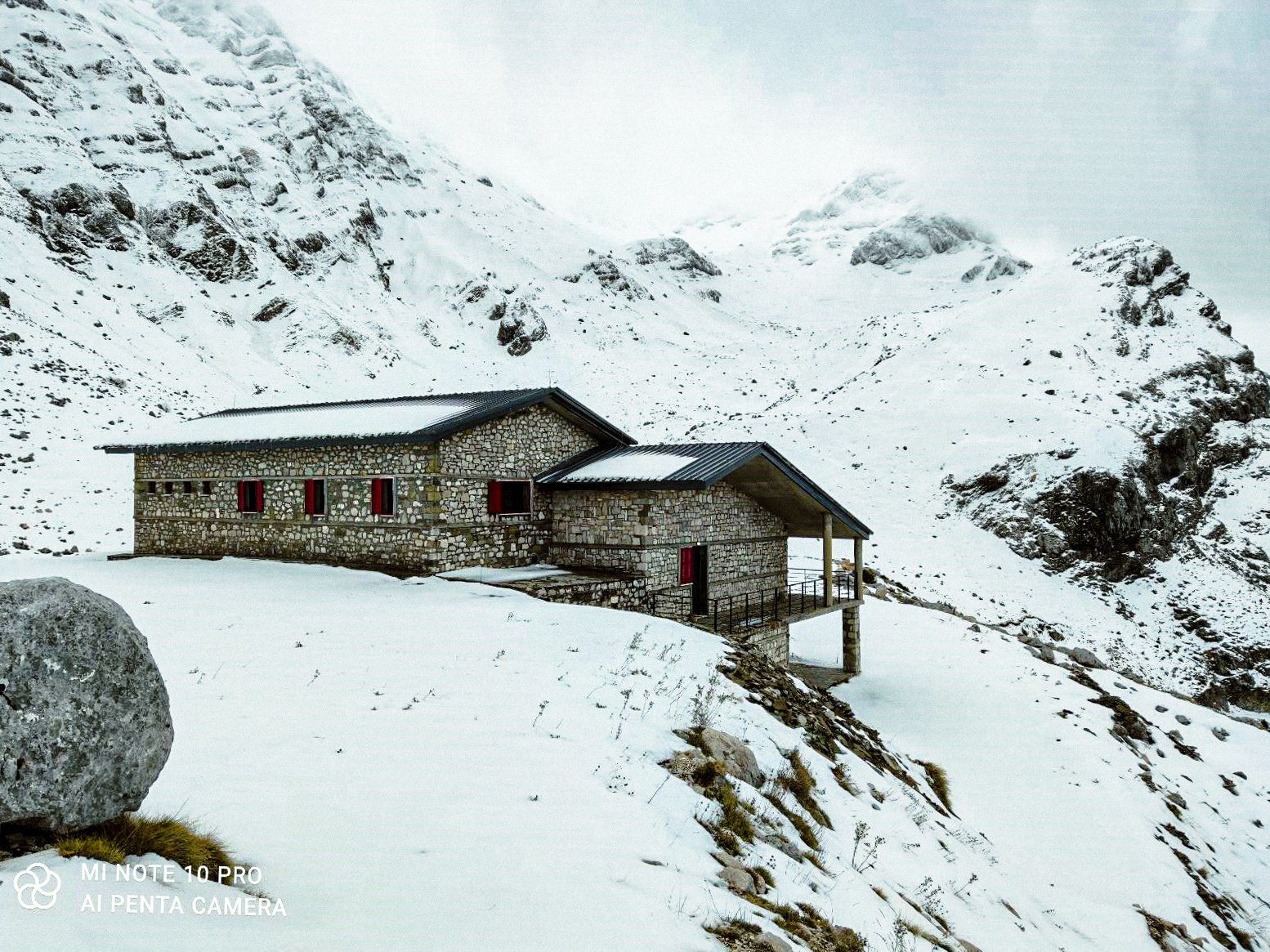 People walking on snowed mountain.