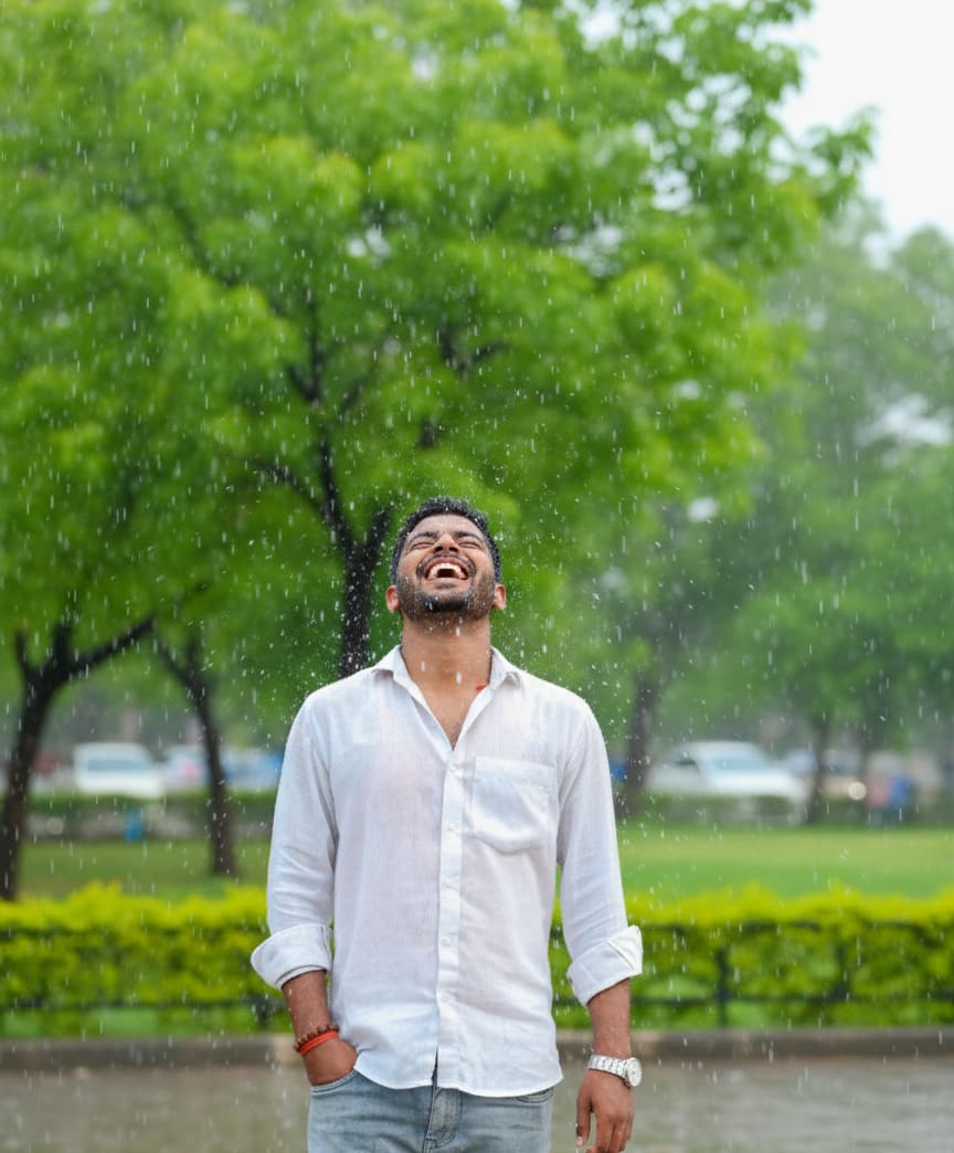 Portrait of a boy laughing in the rain