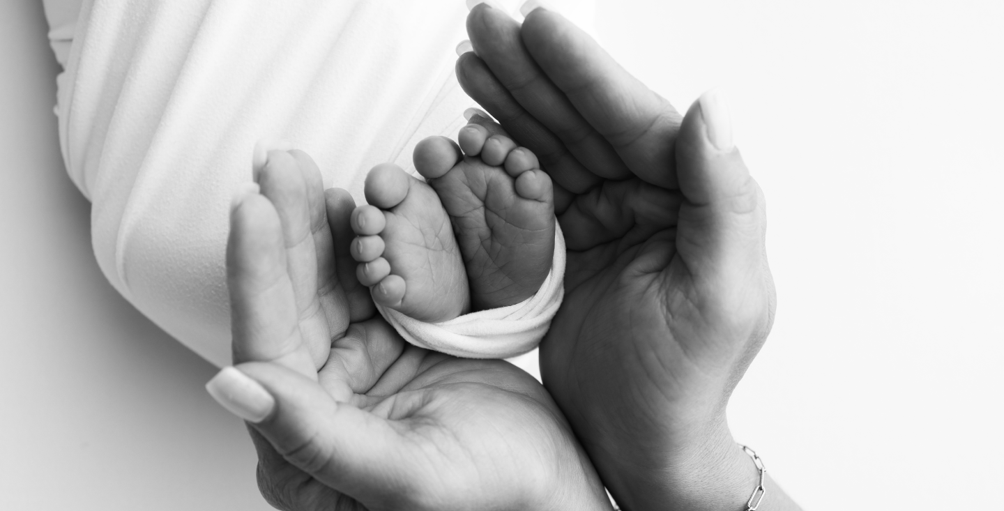 adult-hands-holding-baby-feet