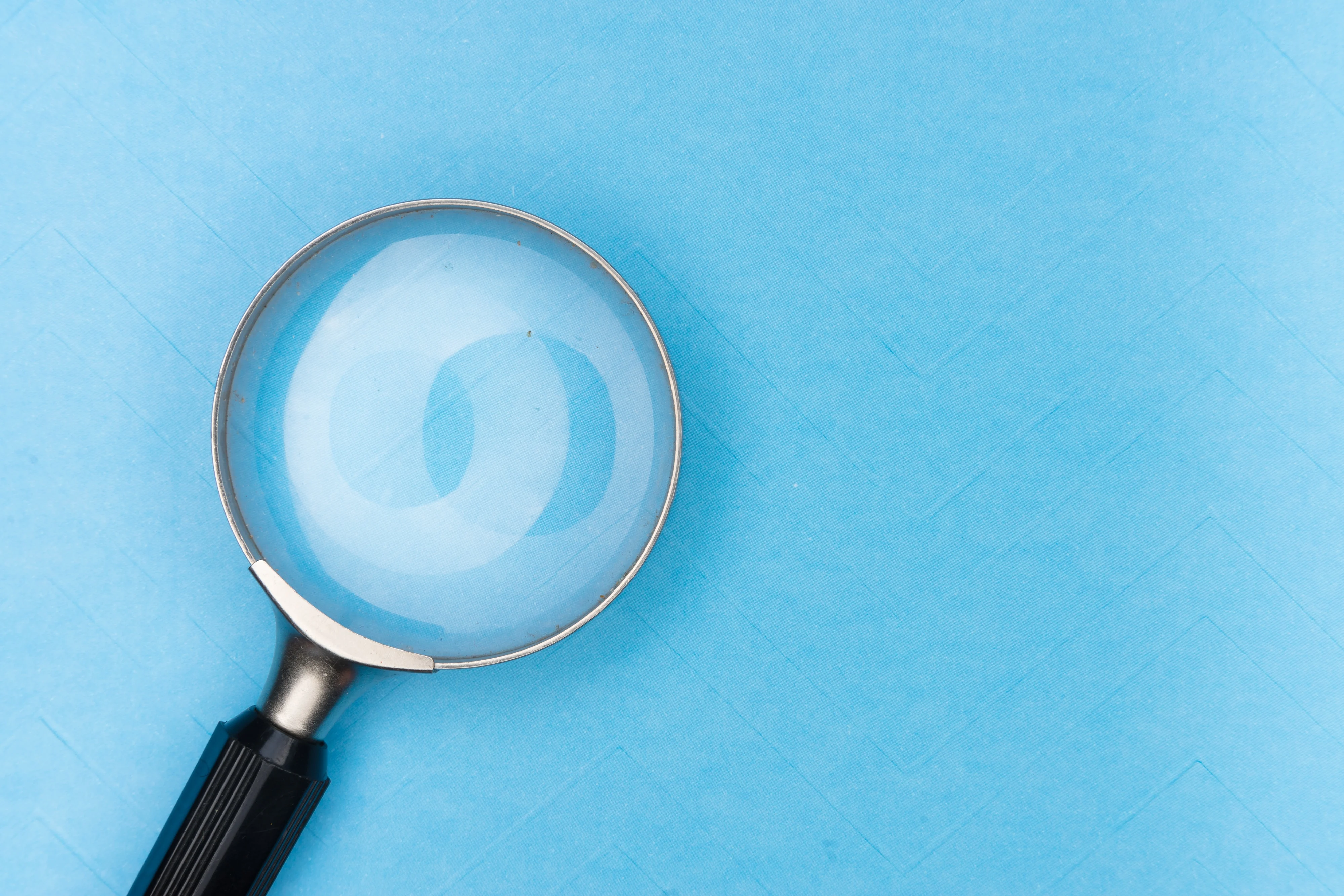 Magnifying glass lying on the blue tile