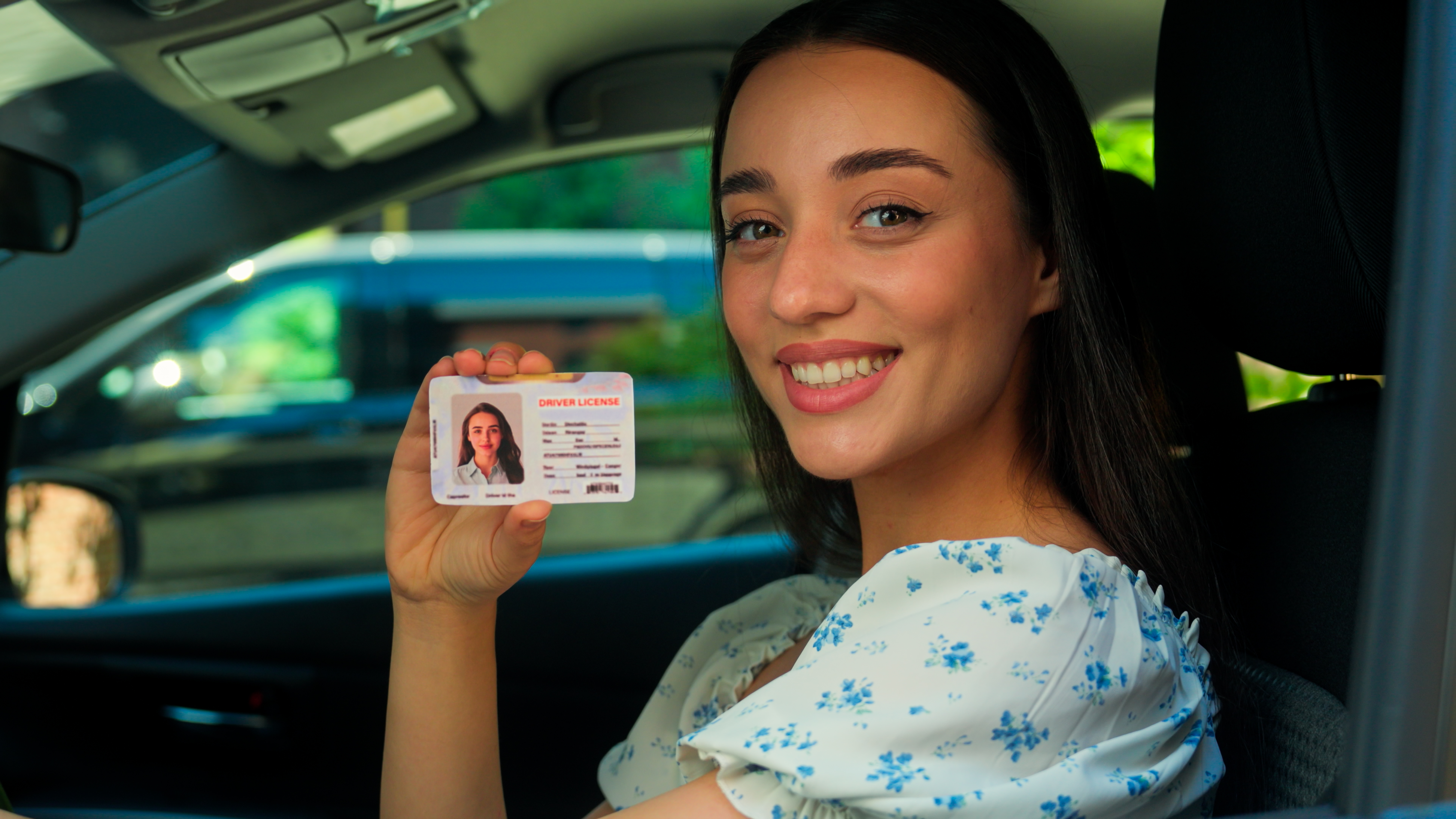 Woman holding a driver license — California REAL ID birth certificate requirements
