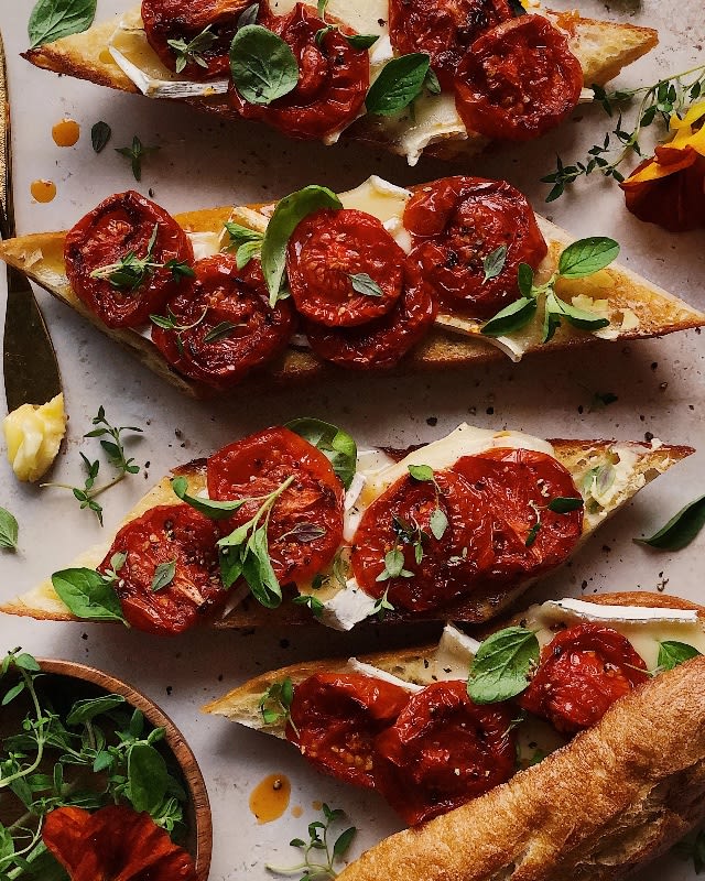 Red Pepper Baked Brie Topped with Sundried Tomatoes, and Pine Nuts served with Crackers or Baguette