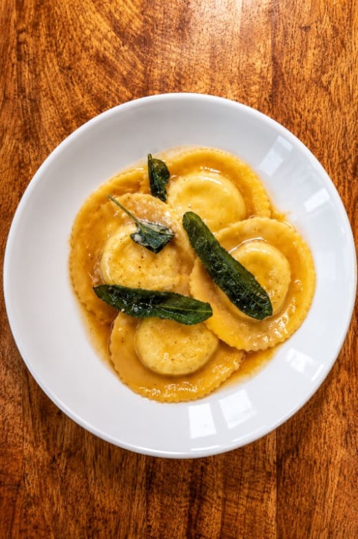 Primi Ravioli Della Casa with Ricotta Cheese, Spinach, and Rosa Sauce