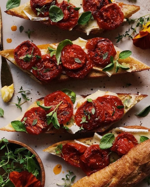 Red Pepper Baked Brie Topped with Sundried Tomatoes, and Pine Nuts served with Crackers or Baguette
