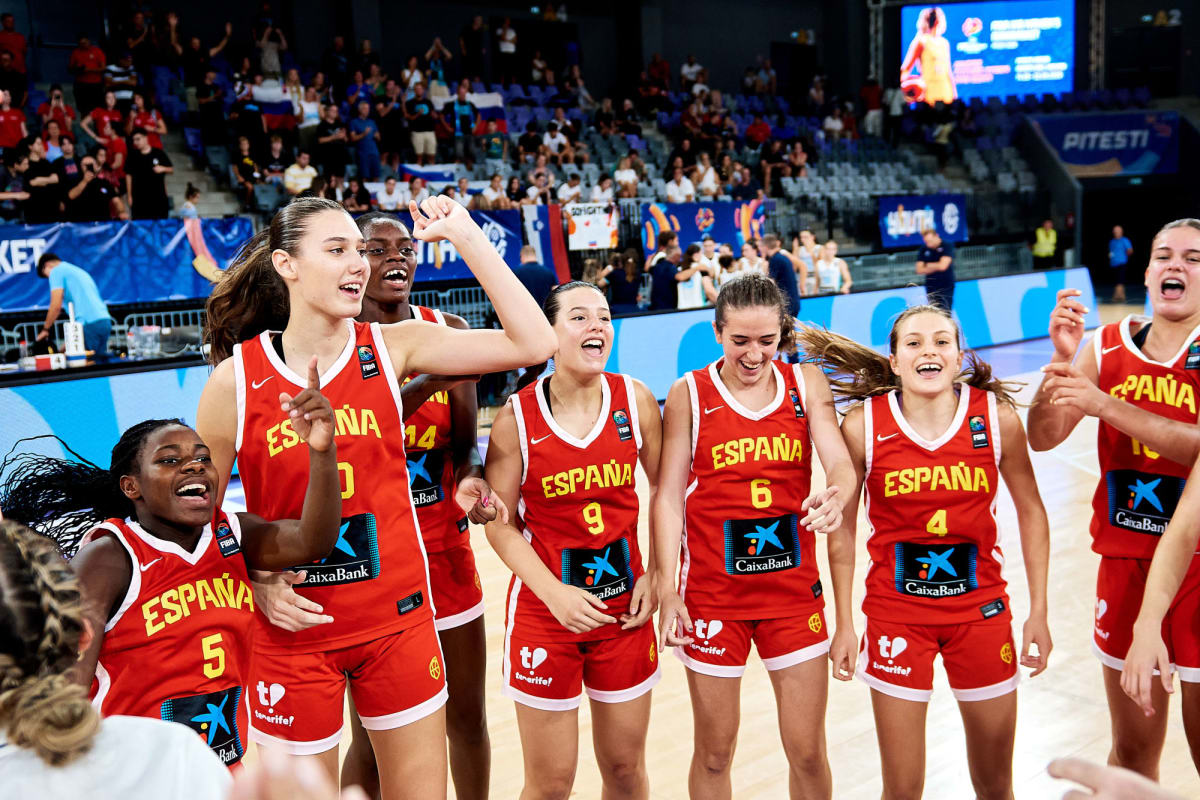 Spanish women's youth basketball team celebrating with gold medals and championship trophy