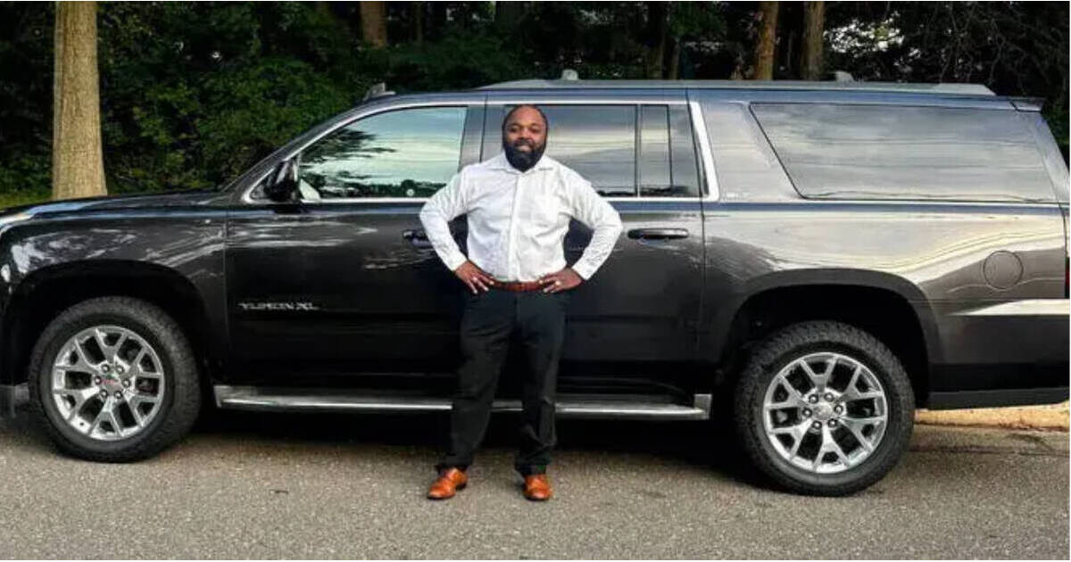 New Brunswick entrepreneur Taoman Napier Sr. standing with his son beside their business vehicles