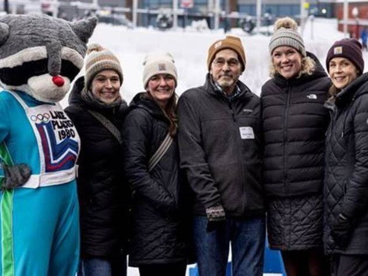 Cancer survivor Michael DeYear with Adirondack Health oncology team members and mascot at Lake Placid skating fundraiser
