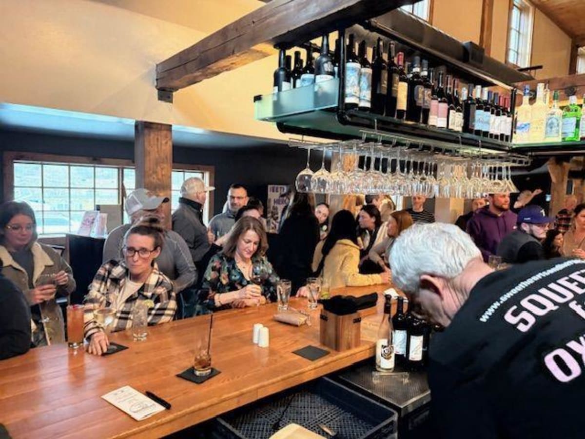 ** Community members gather at restaurant fundraiser supporting youth empathy education program