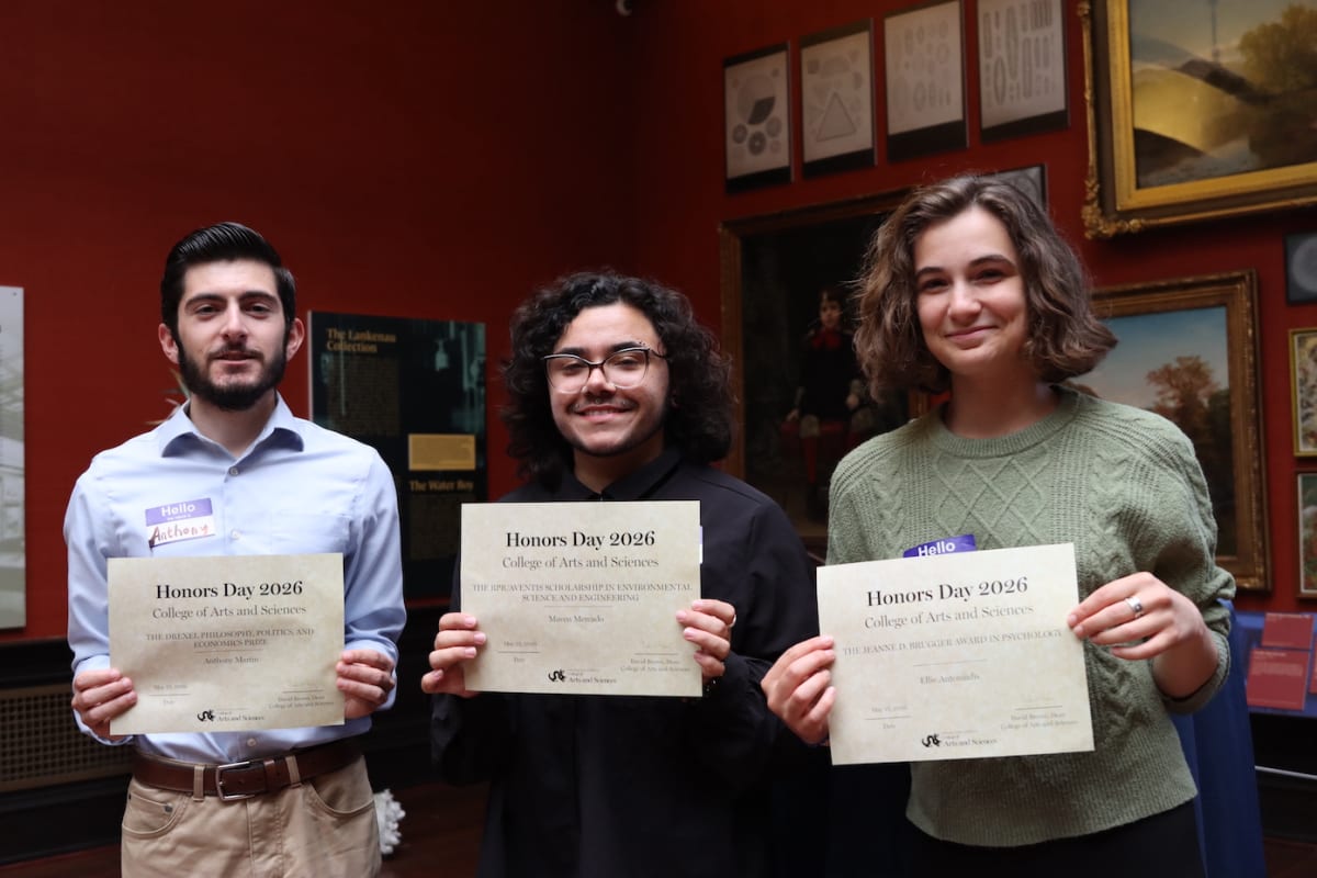 Drexel University students in caps and gowns celebrating academic achievement at Honors Day ceremony