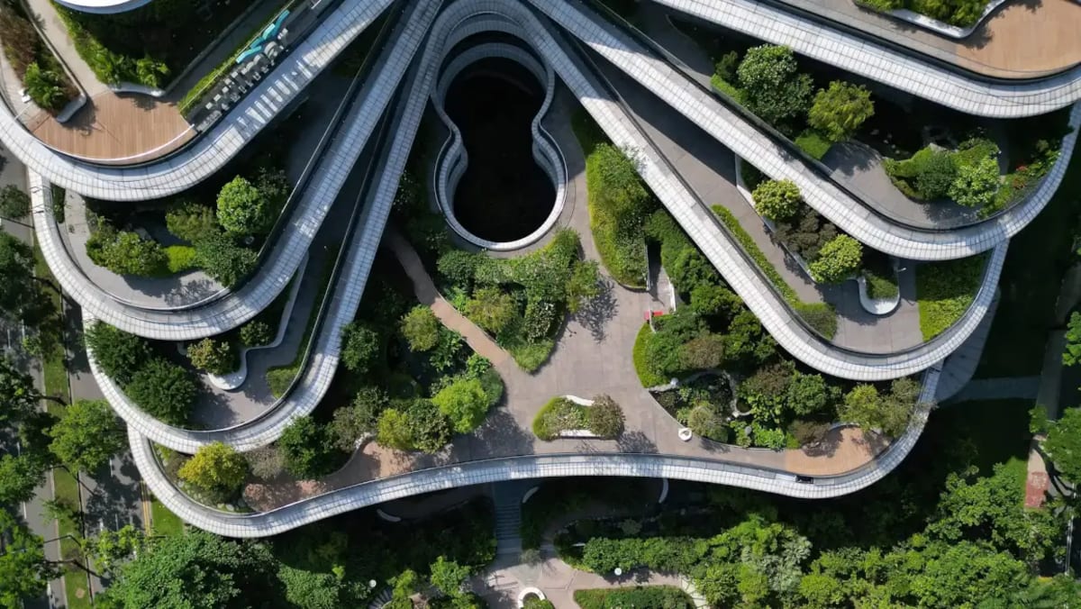Modern Singapore one-north district with green rooftops, tree-lined streets, and connected pedestrian walkways