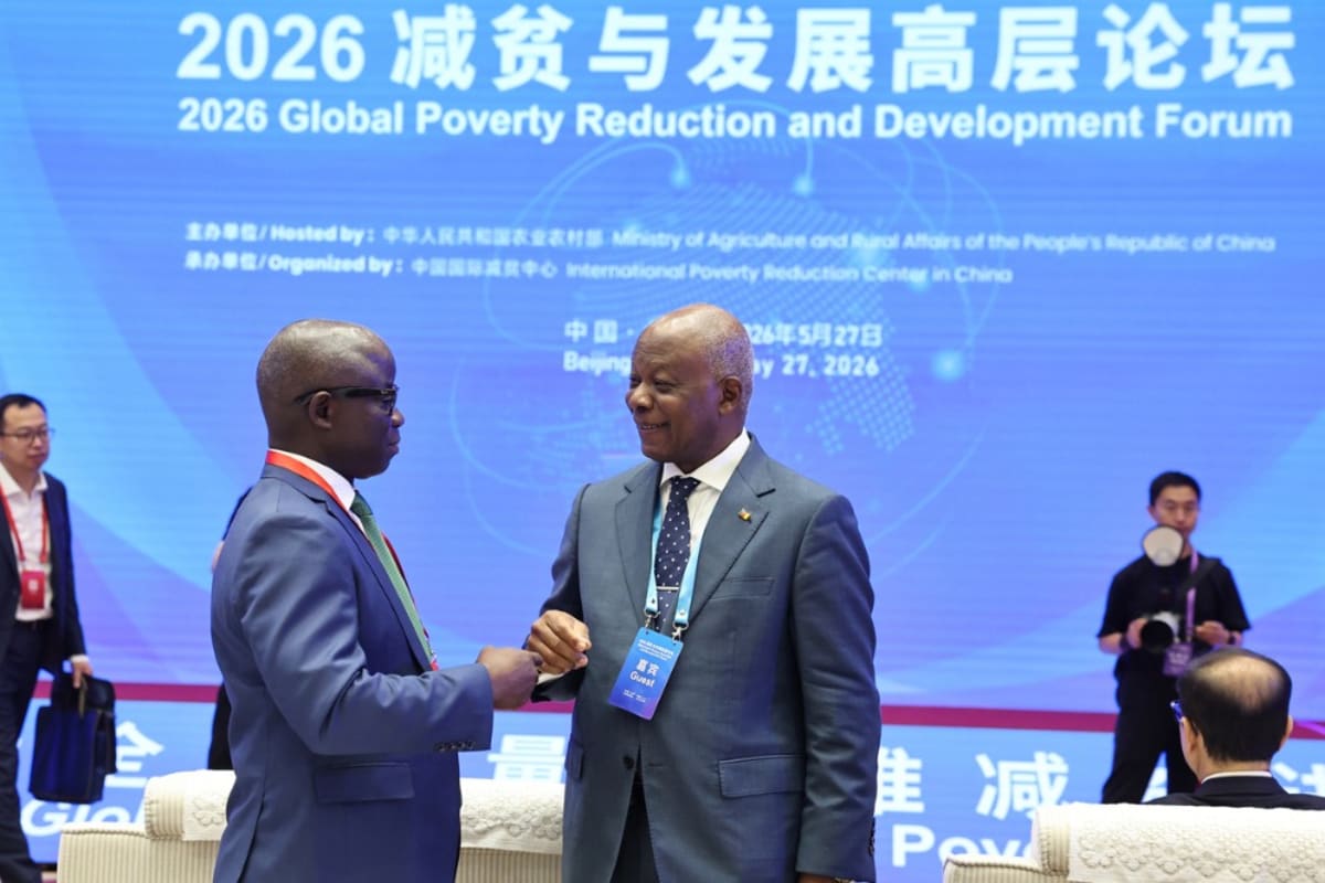 ** Representatives from multiple countries gathering at international development forum in Beijing discussing poverty reduction strategies