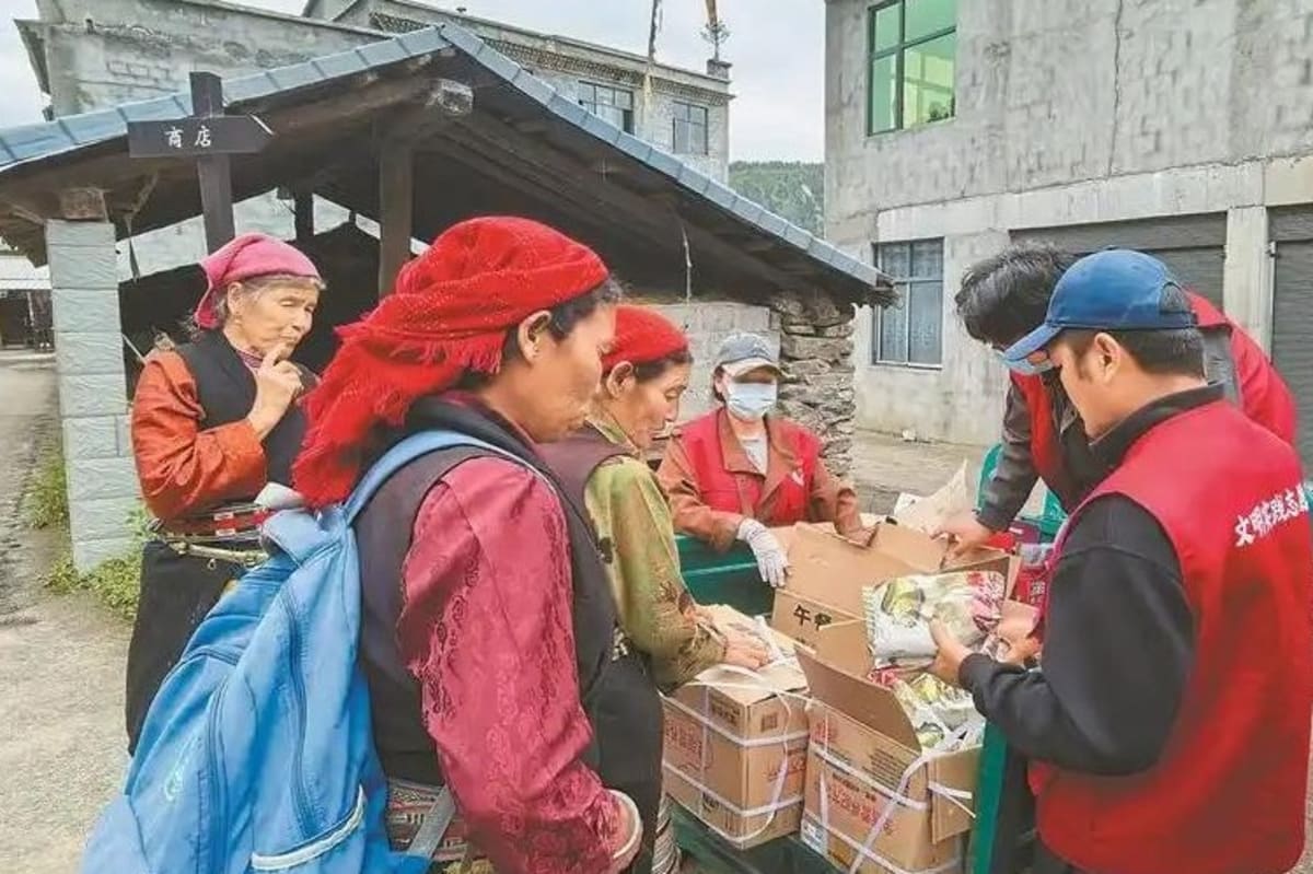 ** Young volunteers sorting disaster relief supplies in boxes at emergency coordination center in Gyirong