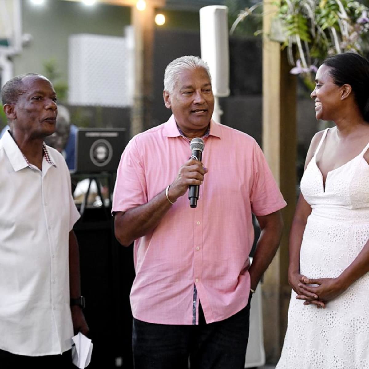 Aviation professional Nari Williams-Singh presents large donation check at school fundraising event in Jamaica