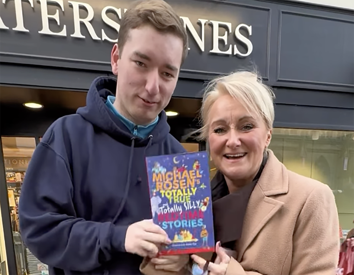 Young man Sebbie Hall smiling warmly while performing one of his many acts of kindness