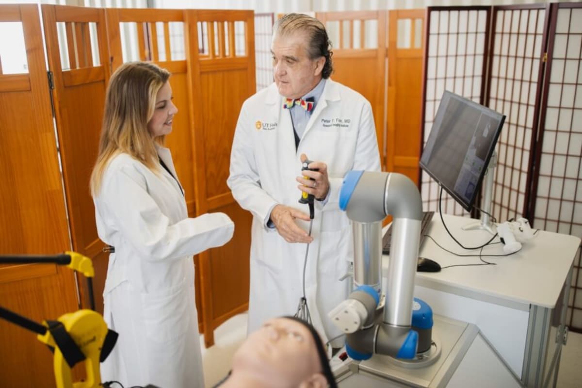 Doctor demonstrates robotic MRI-guided brain stimulation device used in PTSD treatment study