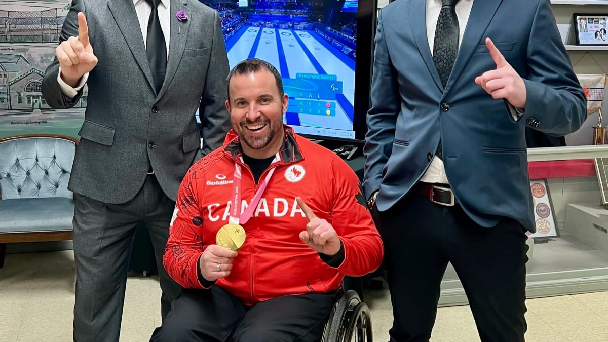 Paralympic wheelchair curling gold medalist Jon Thurston poses with Five Counties Children's Centre representatives
