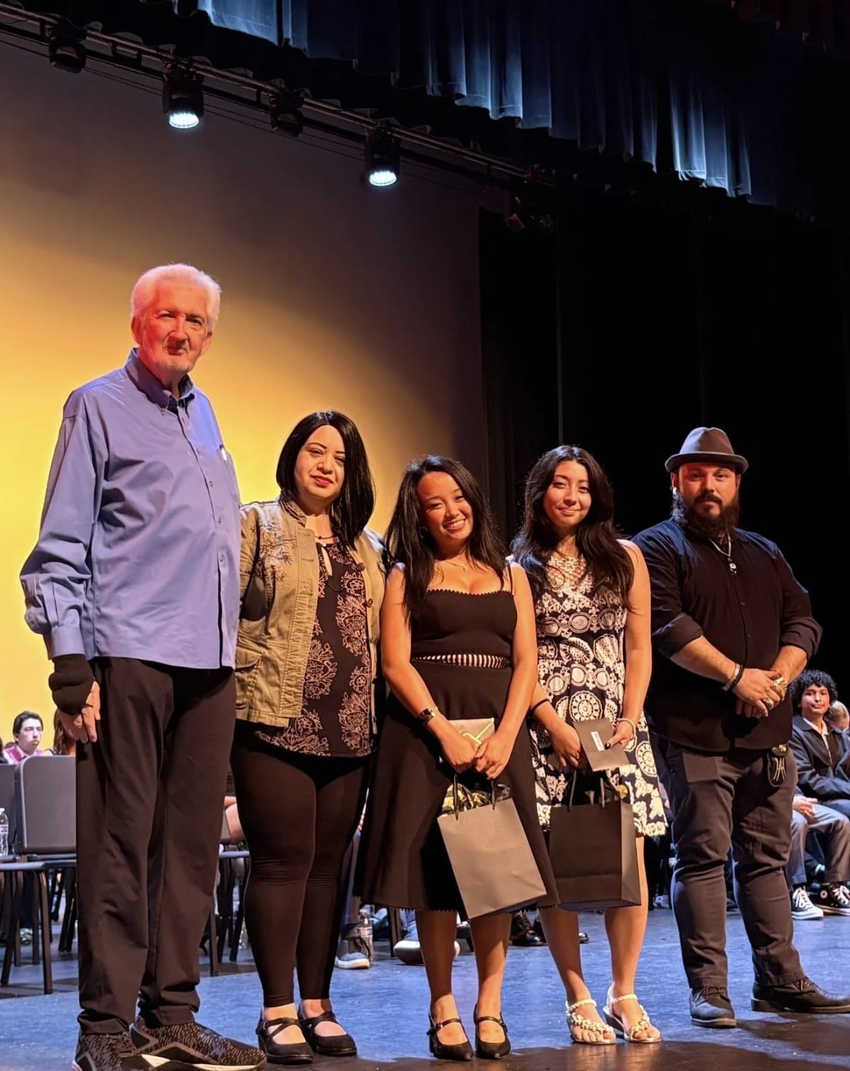 Downey High School scholarship recipients pose with Downey Arts Coalition board members holding certificates