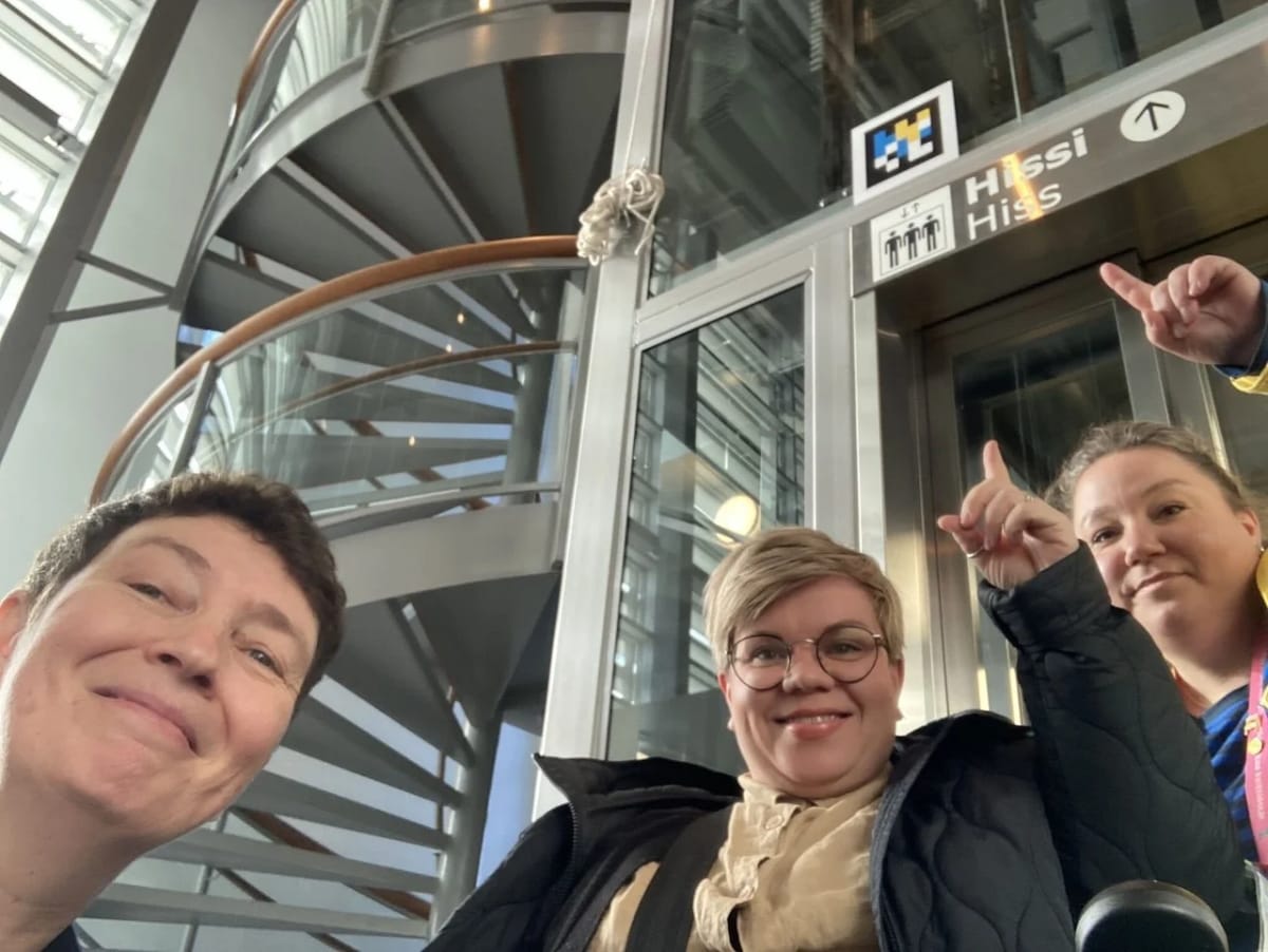 Shopper using smartphone to scan NaviLens accessibility code inside IKEA furniture store