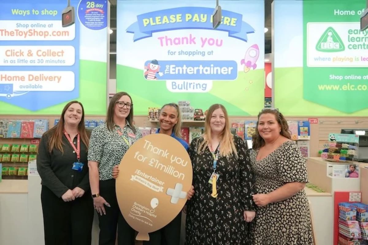 Shoppers at toy store checkout counter making small charitable donations for children's hospitals