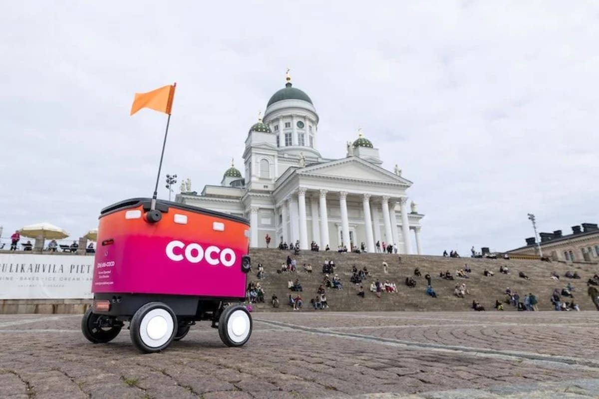 Autonomous delivery robot on Helsinki street carrying food orders for Uber Eats customers