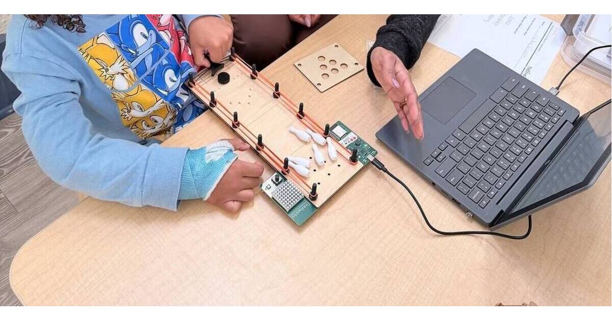 Young children in classroom working on hands-on STEAM building project at Apple Montessori Schools
