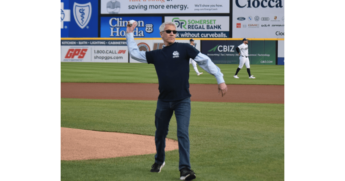 SCVTHS Principal Michael Meyer throwing ceremonial first pitch at Somerset Patriots baseball game