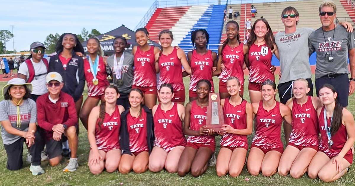 Tate High School girls track and field team celebrating district championship victory together