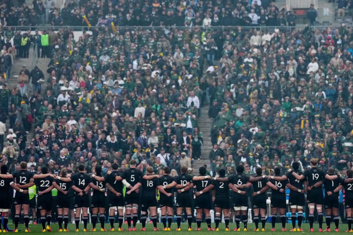 All Blacks rugby players performing haka before packed stadium during historic rivalry tour
