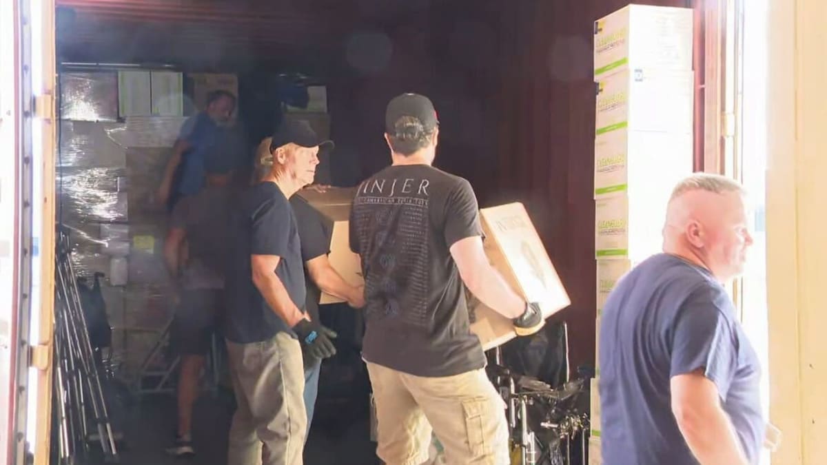 RocMaidan volunteers loading medical supplies and equipment into large shipping container for Ukraine