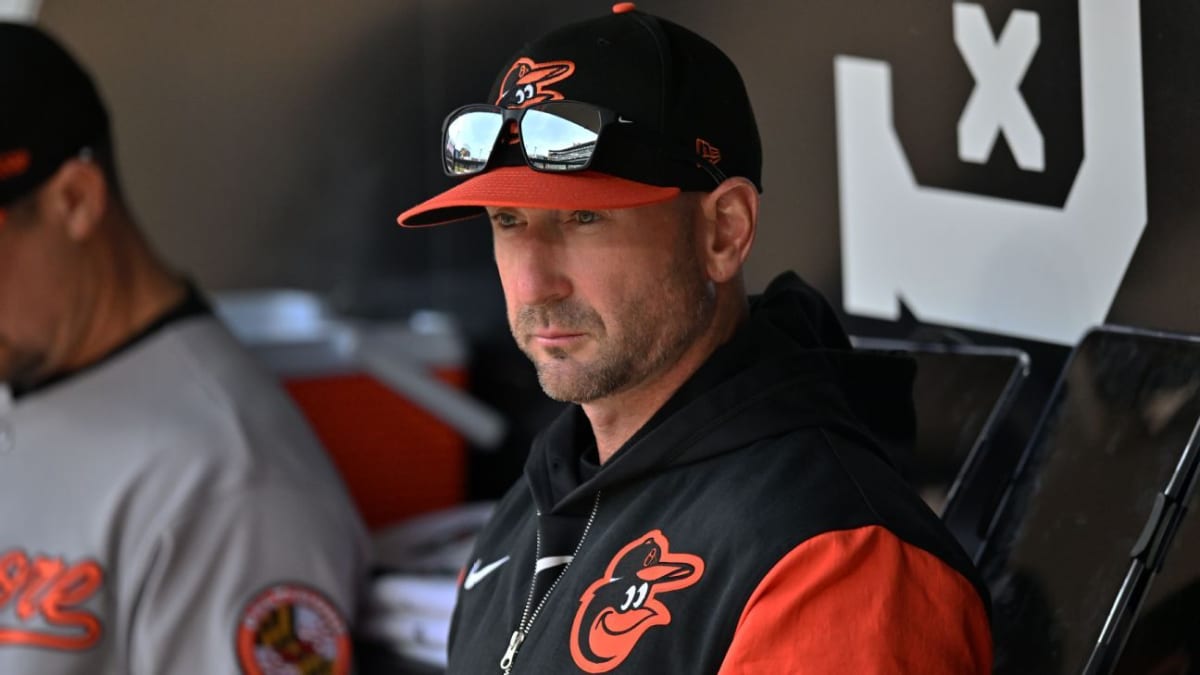 Baltimore Orioles manager Craig Albernaz hugging player Jeremiah Jackson in baseball dugout celebration