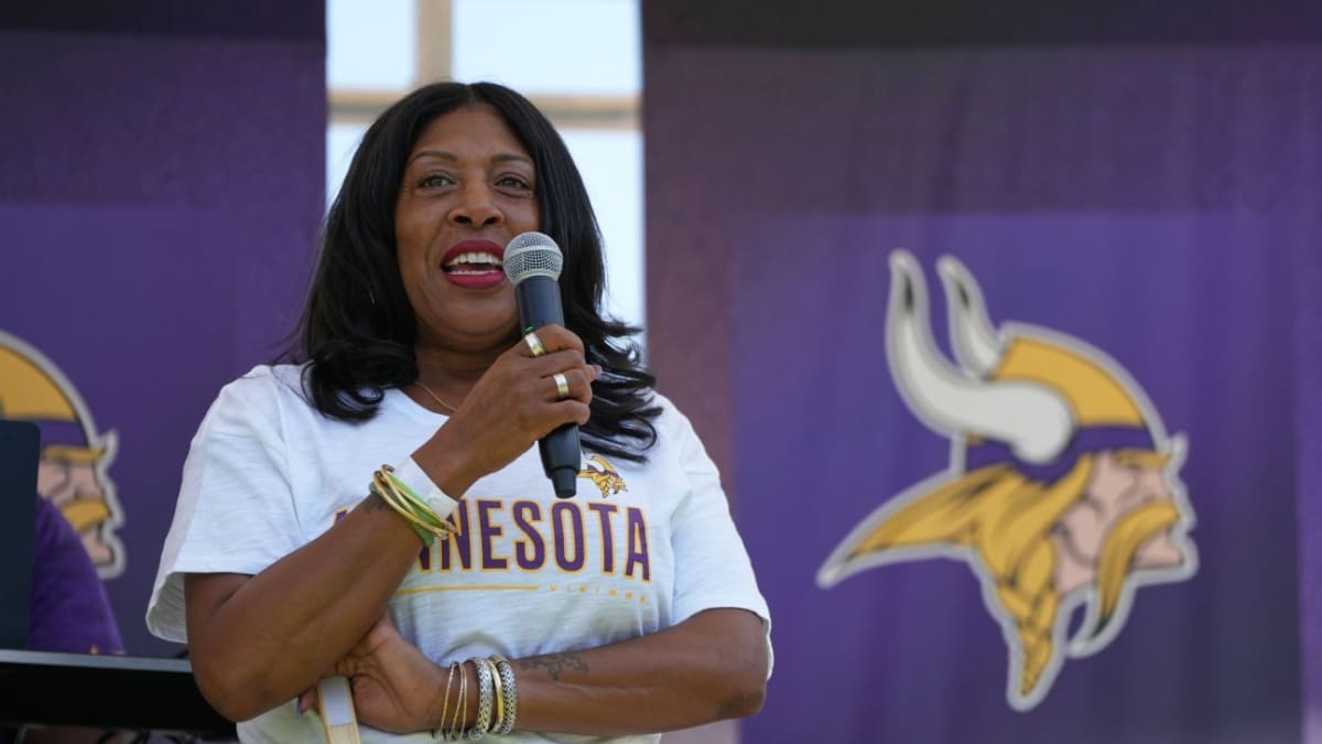 Kelci Stringer smiling at Minnesota Vikings practice facility during 25th anniversary remembrance event