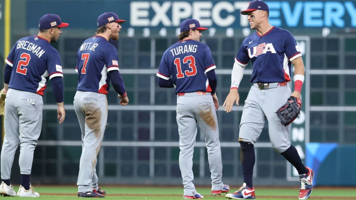 Team USA baseball players celebrating their semifinal advancement at Daikin Park in Houston