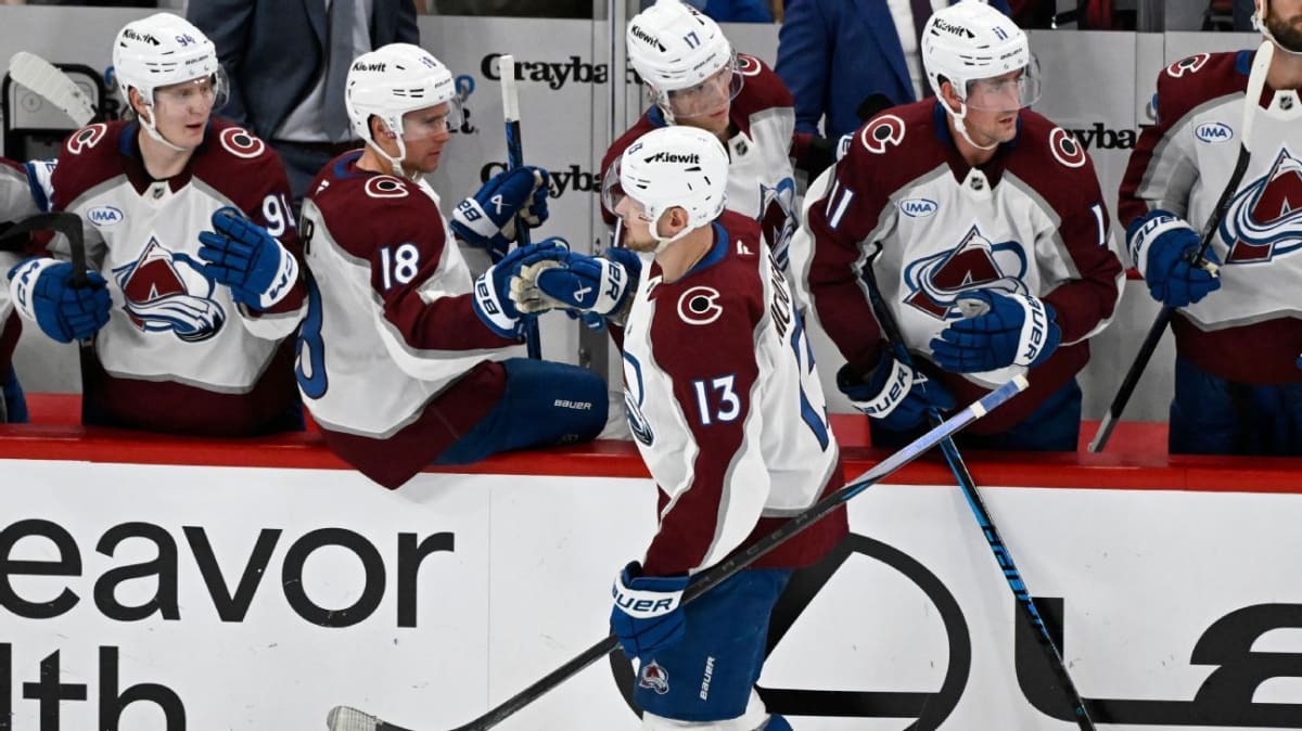 Colorado Avalanche hockey players celebrating on ice after clinching playoff berth victory