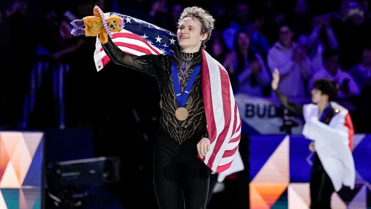 Ilia Malinin celebrating on ice after winning third consecutive world figure skating championship