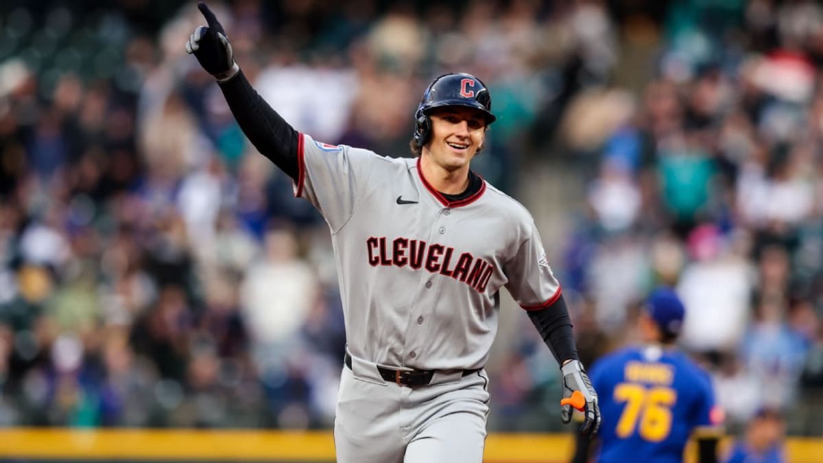 Baseball player Chase DeLauter mid-swing during a game at the plate showing powerful form