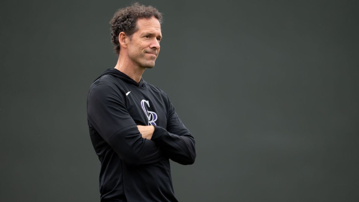 Paul DePodesta standing on baseball field at Colorado Rockies spring training facility in Arizona