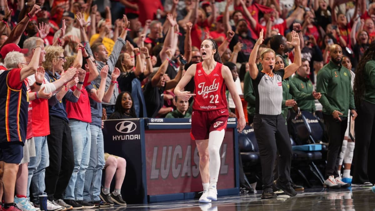 Caitlin Clark celebrating on basketball court after making three-pointer for Indiana Fever
