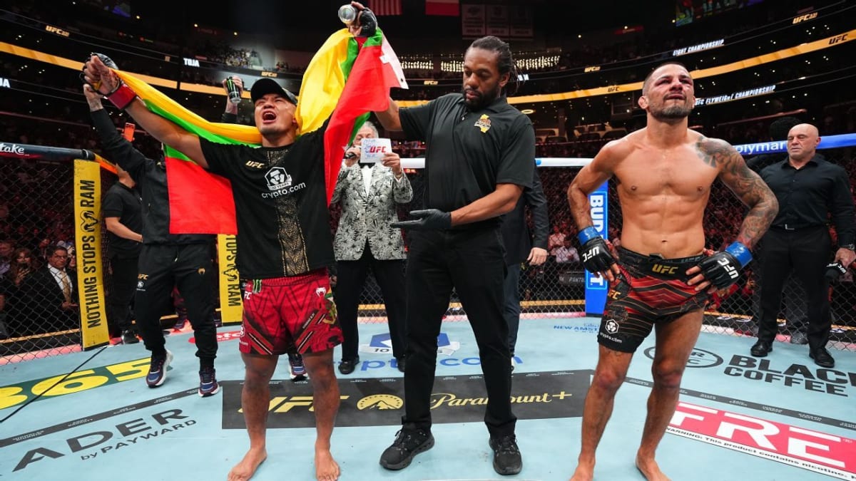 UFC champion Joshua Van celebrating victory in the octagon after defending his flyweight title