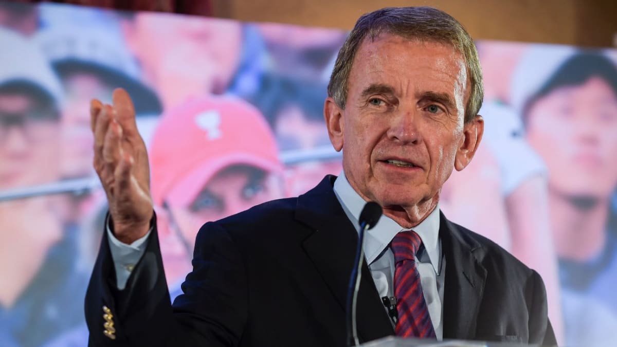 Tim Finchem standing on golf course smiling, former PGA Tour commissioner and philanthropist